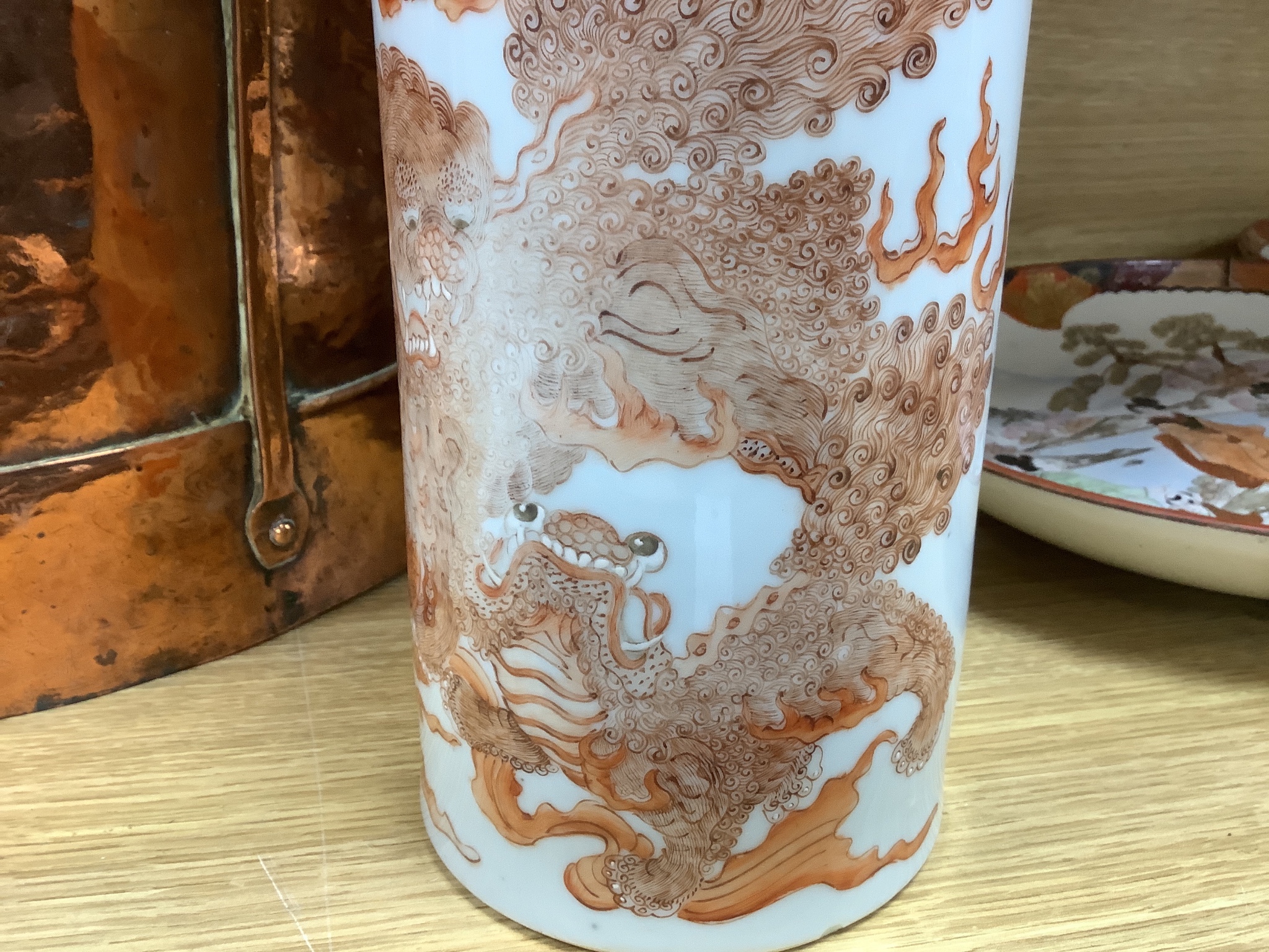 A Chinese cylindrical porcelain vase, painted in iron red, with script, 28cm